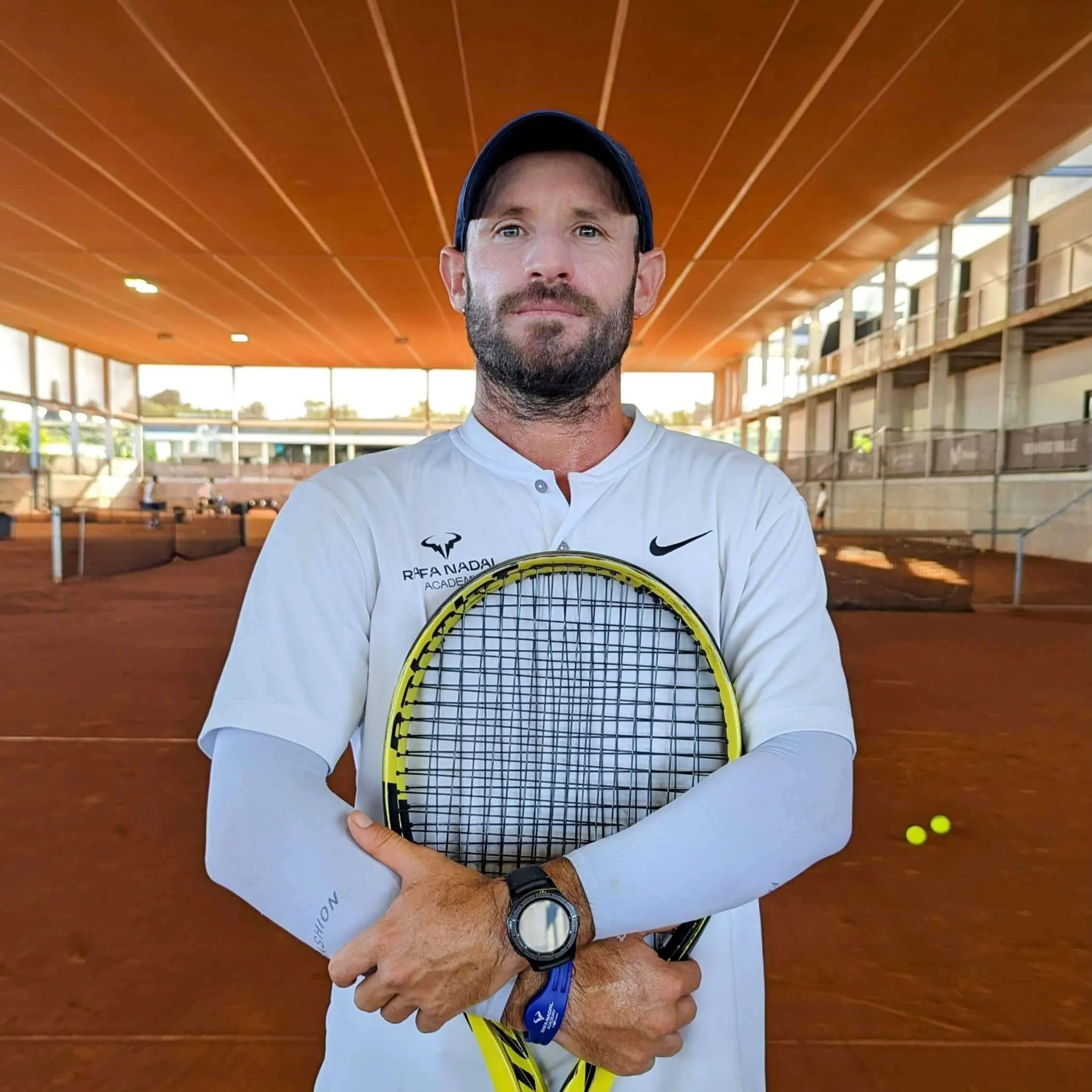 Portrait of the Evolve high performance tennis coach Fernando Rossaroli on a clay court, representing our expertise in science based tennis training and tennis player development.